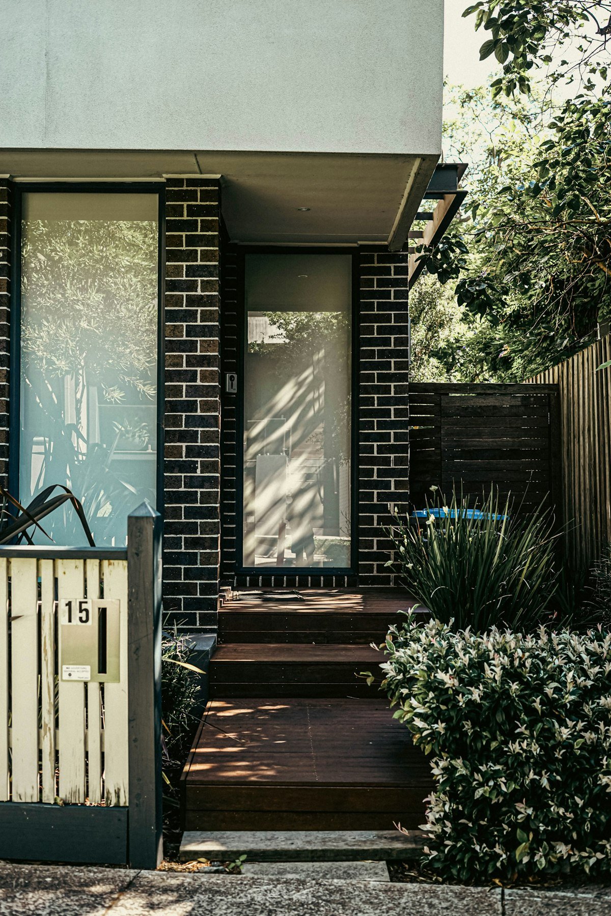 A welcoming front porch with brick walls and greenery